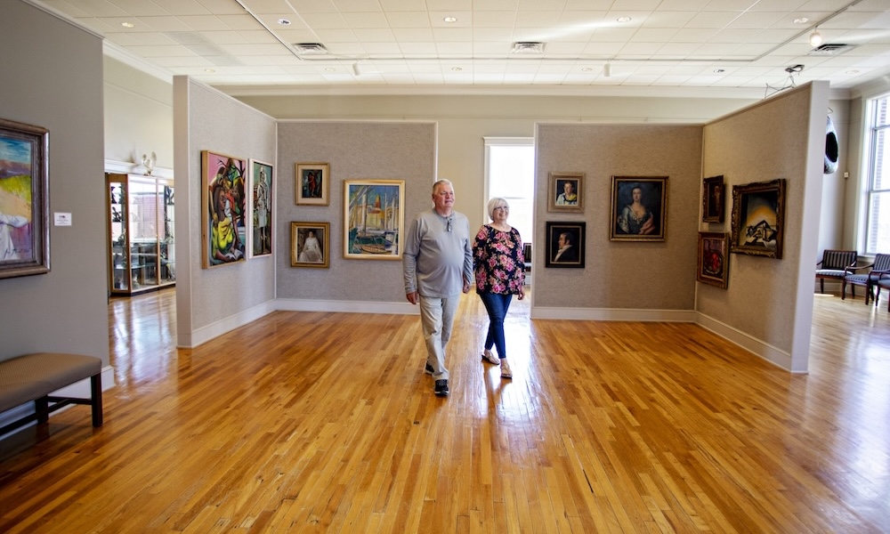 Couple walking in the Caldwell gallery